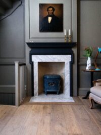 Interior with grey oak tate bute floor and grey panelling and marble fireplace with portraitwidth=