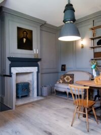 Tate bute flooring in almshouse with marble fireplace and grey panelingwidth=